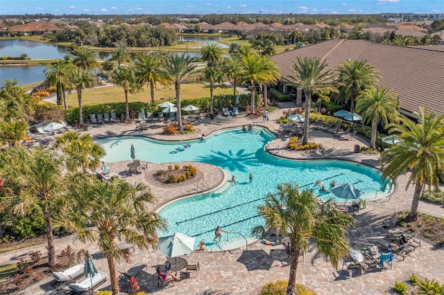 community pool with a water view and a patio