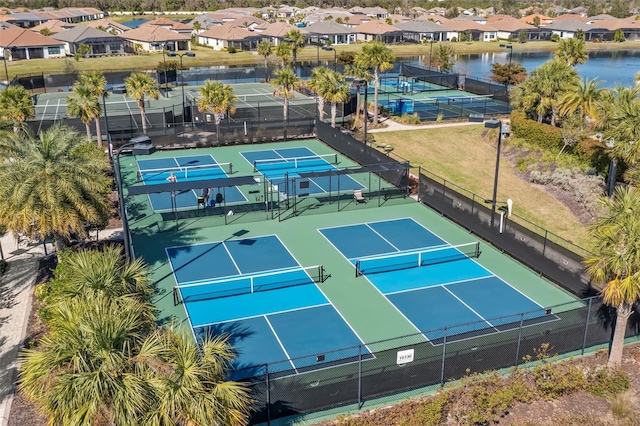 view of sport court featuring fence and a residential view