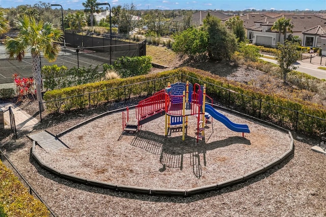 communal playground featuring fence