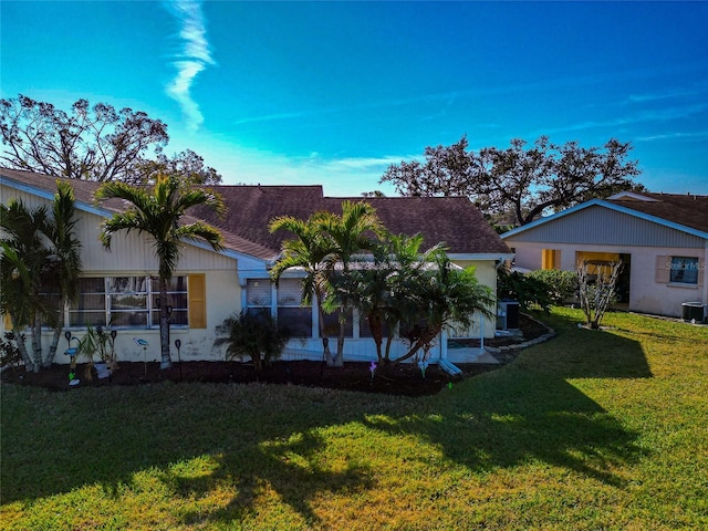 exterior space with cooling unit and a lawn