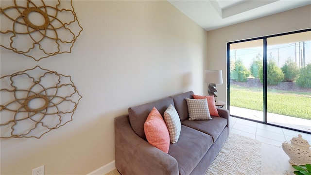 living room with lofted ceiling and light tile patterned floors