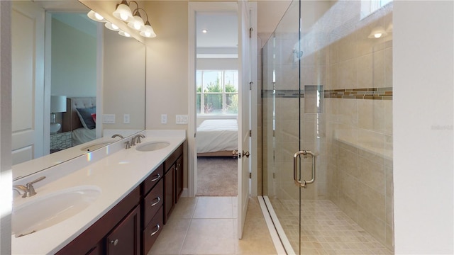 bathroom with tile patterned flooring, vanity, a notable chandelier, and an enclosed shower