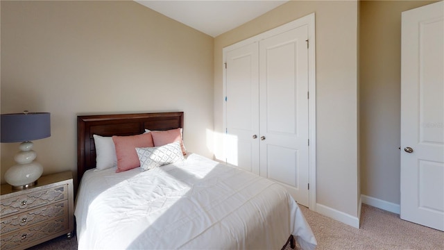 bedroom with light colored carpet and a closet