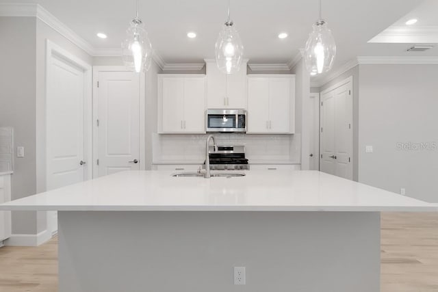 26930 Lark Ct, Punta Gorda, FL 33955 - kitchen with stainless steel appliances, light wood-style floors, crown molding, a sink, and light countertops