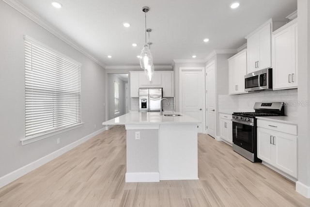 26930 Lark Ct, Punta Gorda, FL 33955 - kitchen with appliances with stainless steel finishes, a sink, backsplash, recessed lighting, and an island with sink