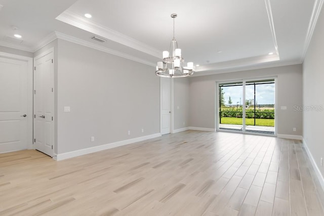 26930 Lark Ct, Punta Gorda, FL 33955 - spare room with a tray ceiling, a chandelier, light wood finished floors, recessed lighting, and ornamental molding