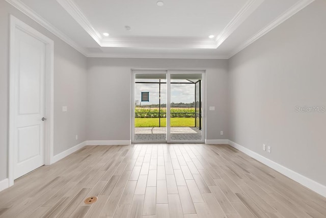 26930 Lark Ct, Punta Gorda, FL 33955 - spare room with a raised ceiling, light wood finished floors, baseboards, and crown molding