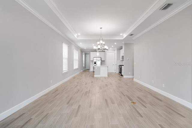26930 Lark Ct, Punta Gorda, FL 33955 - unfurnished living room with a chandelier, light wood-type flooring, a tray ceiling, baseboards, and recessed lighting