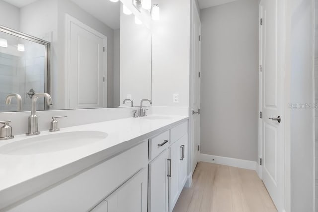 26930 Lark Ct, Punta Gorda, FL 33955 - full bathroom with double vanity, a shower with door, and baseboards