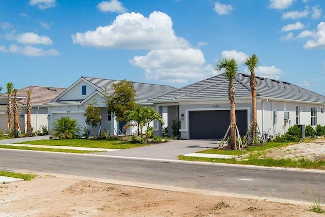 26930 Lark Ct, Punta Gorda, FL 33955 - view of front of home featuring driveway, an attached garage, stucco siding, and a tile roof