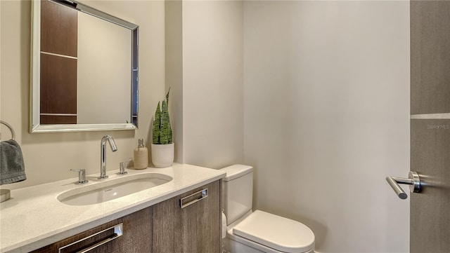 bathroom with toilet and vanity