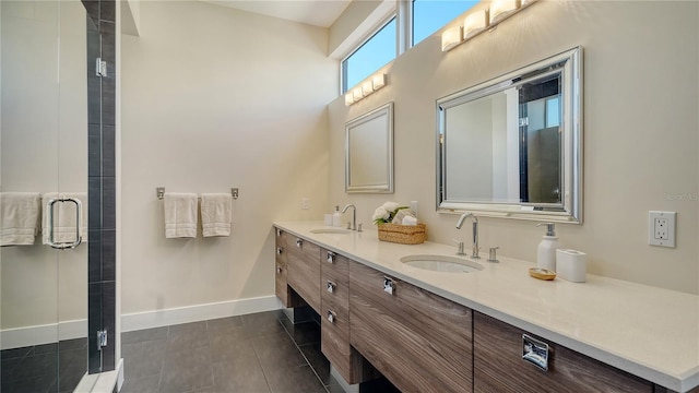 bathroom featuring double vanity, baseboards, a sink, and tile patterned floors