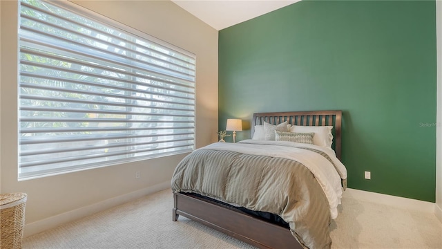 bedroom with baseboards and carpet flooring