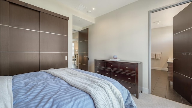 bedroom featuring recessed lighting, a closet, light tile patterned flooring, and baseboards