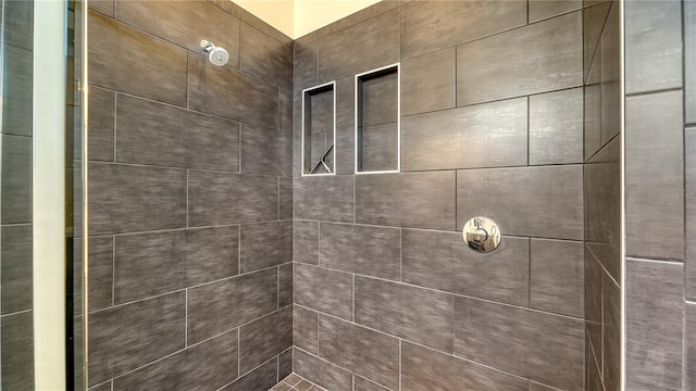 bathroom with a tile shower