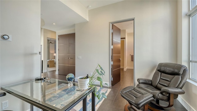 home office with dark tile patterned floors and baseboards