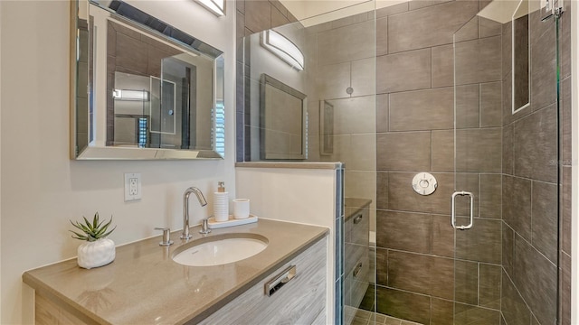 bathroom featuring a stall shower and vanity