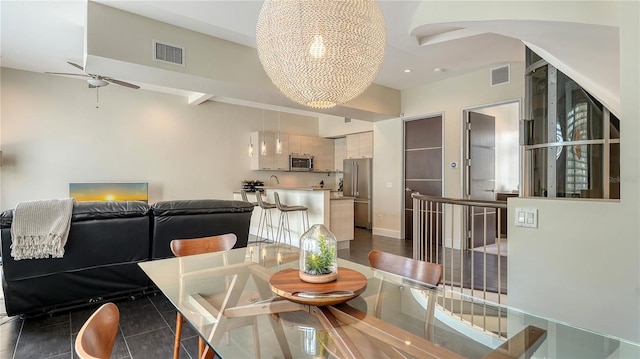 dining area with ceiling fan with notable chandelier, visible vents, and baseboards