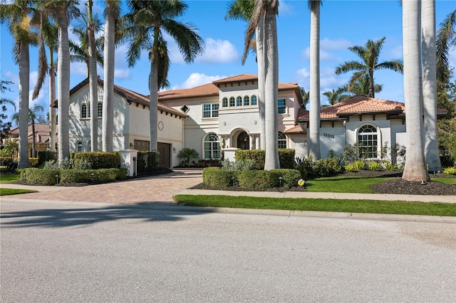 mediterranean / spanish home featuring a garage