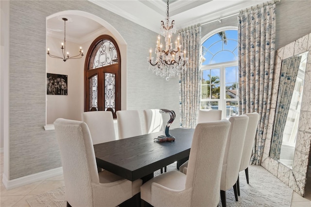 13315 Palmers Creek Ter, Lakewood Ranch, FL 34202 - dining space featuring light tile patterned flooring, a towering ceiling, ornamental molding, and a notable chandelier