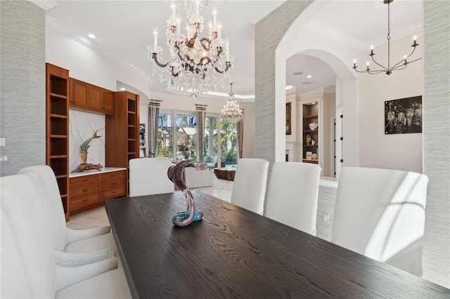 13315 Palmers Creek Ter, Lakewood Ranch, FL 34202 - dining room featuring crown molding, built in shelves, and a notable chandelier