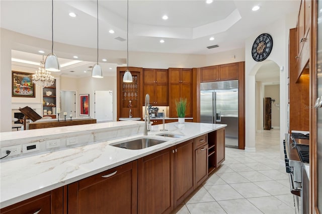 13315 Palmers Creek Ter, Lakewood Ranch, FL 34202 - kitchen with built in fridge, a raised ceiling, sink, and decorative light fixtures