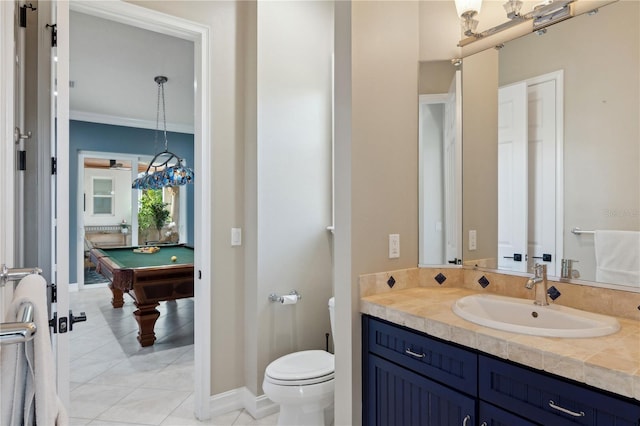 13315 Palmers Creek Ter, Lakewood Ranch, FL 34202 - bathroom with tile patterned flooring, vanity, pool table, toilet, and crown molding