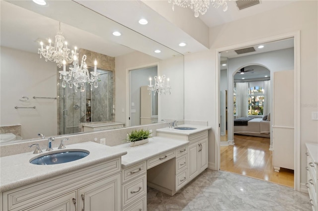 13315 Palmers Creek Ter, Lakewood Ranch, FL 34202 - bathroom with vanity, ceiling fan with notable chandelier, and a shower with shower door