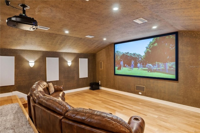 13315 Palmers Creek Ter, Lakewood Ranch, FL 34202 - home theater room with lofted ceiling and hardwood / wood-style flooring
