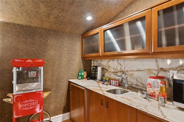 13315 Palmers Creek Ter, Lakewood Ranch, FL 34202 - kitchen featuring tasteful backsplash, light stone countertops, and sink