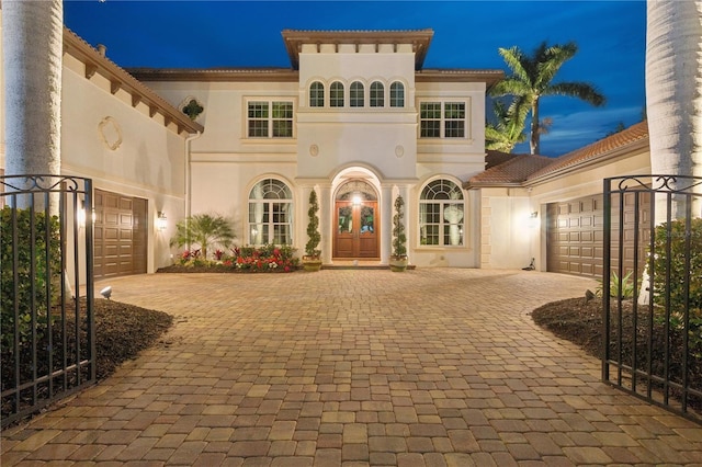 mediterranean / spanish house featuring french doors and a garage