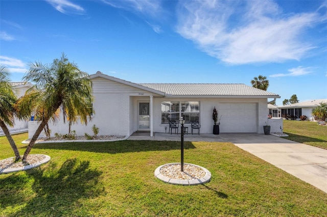 single story home with a garage and a front lawn