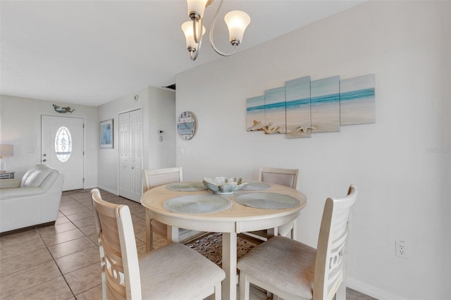 dining space with a chandelier and light tile patterned flooring