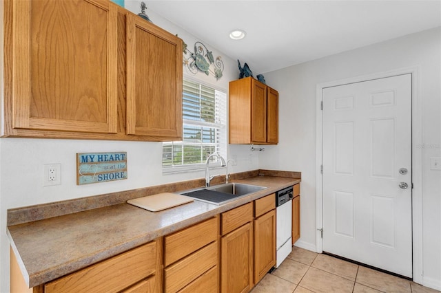 kitchen featuring sink, light tile patterned floors, and dishwasher