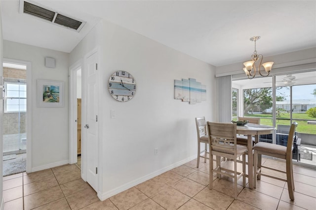 dining room featuring an inviting chandelier, plenty of natural light, and light tile patterned flooring