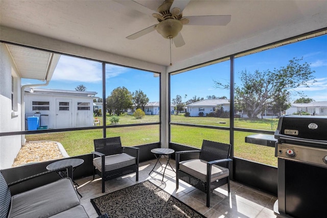 sunroom featuring ceiling fan