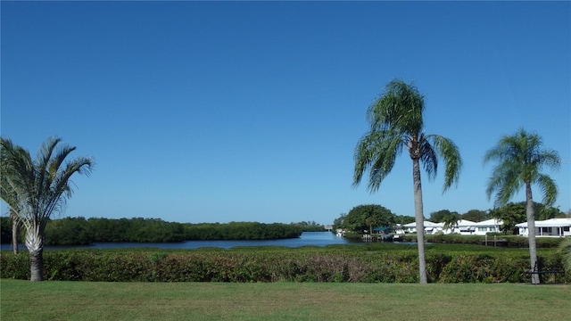 view of property's community featuring a water view and a yard