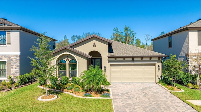 view of front of house with a front yard and a garage