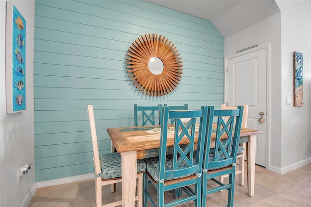 tiled dining area with wood walls