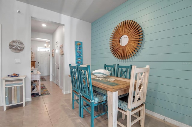 tiled dining area with an inviting chandelier