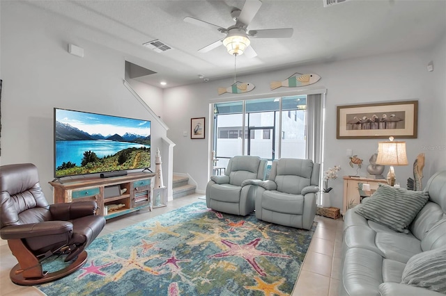 living room featuring light tile patterned flooring and ceiling fan