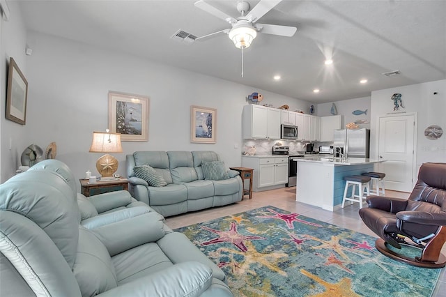 tiled living room featuring ceiling fan