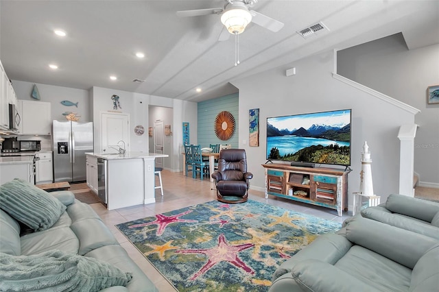 tiled living room featuring sink and ceiling fan