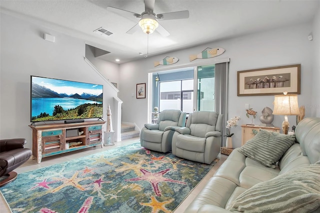 tiled living room featuring ceiling fan