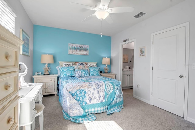 carpeted bedroom featuring ceiling fan and ensuite bathroom