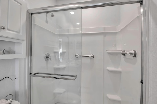 bathroom with a shower with door