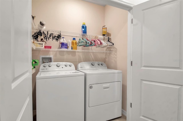 clothes washing area with washing machine and dryer