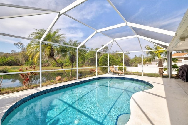 view of pool with glass enclosure and a patio area