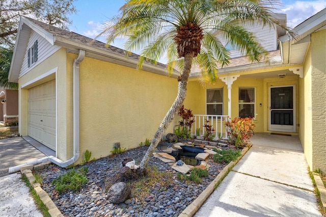 view of property exterior featuring a garage and covered porch