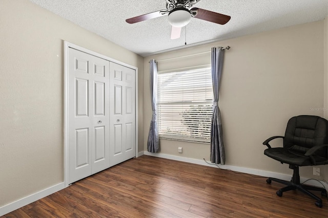 unfurnished office with ceiling fan, dark hardwood / wood-style floors, and a textured ceiling